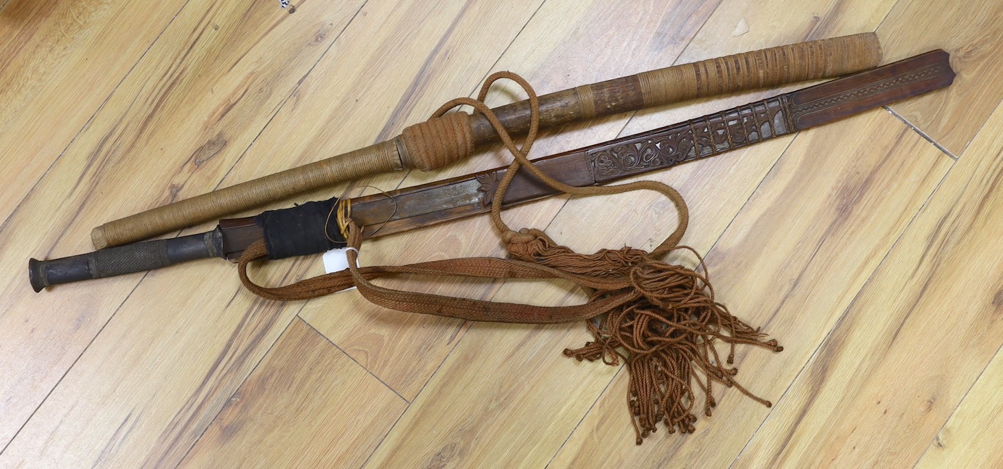 Two Burmese dha swords.